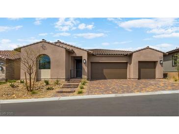 Charming single-story home with a three-car garage and desert landscaping at 346 Tigullio Ave, Henderson, NV 89011