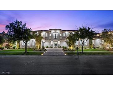 Elegant two-story home featuring manicured landscaping and a symmetrical facade at 42 Ravenswood Ave, Las Vegas, NV 89141