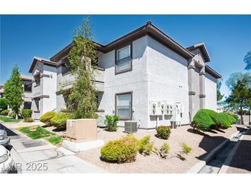 A well-maintained two-story condo featuring neutral stucco and brown trim, set amongst desert landscaping at 45 Maleena Mesa St # 223, Henderson, NV 89074