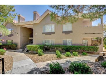 Inviting condo exterior with manicured landscaping and stairway access to the upper units at 700 Capri Dr # 27B, Boulder City, NV 89005