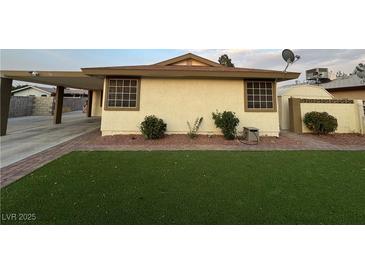 Exterior view of home showing landscaped yard, and carport at 706 Red Lake Way, Las Vegas, NV 89110