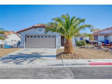Charming single-story home with a xeriscaped front yard and mature palm tree enhancing its curb appeal at 7405 Saybrook Point Dr, Las Vegas, NV 89128