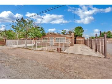 Charming single-story home with a white fence and drought resistant landscaping in the front yard at 75 N 27Th St, Las Vegas, NV 89101