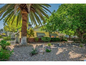 Charming single-story home with desert landscaping, mature trees, and a welcoming curb appeal at 1115 Melville Dr, Las Vegas, NV 89102