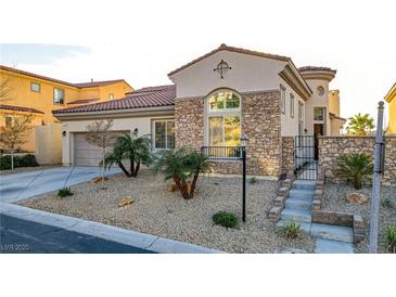 Charming stone-accented home featuring a desert landscaped front yard and attached two-car garage at 1223 Casa Palermo Circle Cir, Henderson, NV 89011