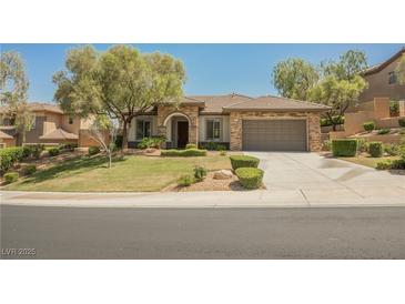 Charming single-story home features well-manicured lawn and two-car garage at 40 Stonemark Dr, Henderson, NV 89052