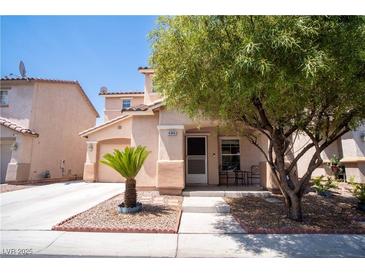 Charming two-story home with a well-manicured lawn and a cozy front porch area at 4945 Volcanic Rock Ln, Las Vegas, NV 89122