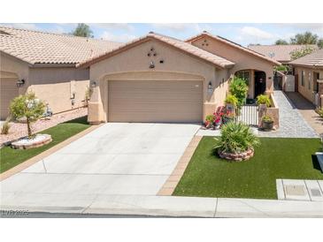 Charming single-story home featuring desert landscaping, a two-car garage, and a welcoming front entryway at 6114 Saddle Horse Ave, Las Vegas, NV 89122
