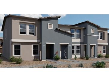Modern townhome exterior showcasing contemporary design and desert landscaping for an appealing curb appeal at 7376 Axel Creek St # Lot 188, North Las Vegas, NV 89084