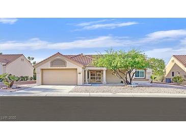 Charming single-story home featuring a well-maintained front yard and attached two-car garage at 8924 Signal Terrace Dr, Las Vegas, NV 89134