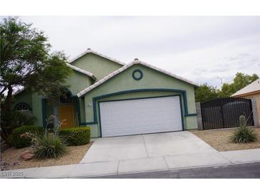 Charming single-story home with a two-car garage, landscaped front yard, and desert landscaping at , Las Vegas, NV 89130