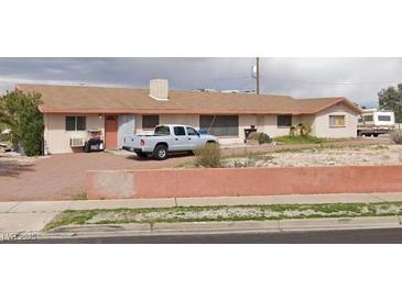 Single story home featuring neutral tones and a well-maintained front yard at 217 Kola St, Henderson, NV 89015