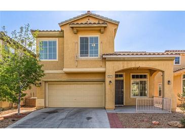Inviting two-story home featuring a two-car garage and covered front porch at 2621 Rainbow Glow St, North Las Vegas, NV 89030