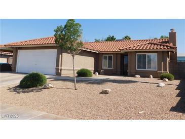 Charming home features a low-maintenance front yard, red tile roof, and two-car garage at 391 Newbury Ct, Henderson, NV 89015