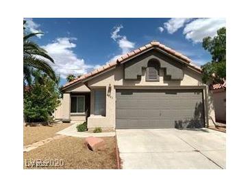Charming single-story home with a well-maintained front yard and a two-car garage at 4021 Broadriver Dr, Las Vegas, NV 89108