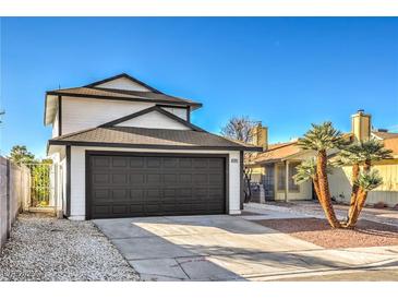Charming two-story home featuring a spacious two-car garage and mature palm trees at 5825 Bent Branch Ln, Las Vegas, NV 89142