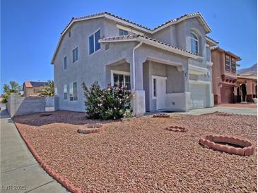Charming two-story home featuring a xeriscaped front yard with desert landscaping and lovely curb appeal at 6042 Thorne Bay Ct, Las Vegas, NV 89110