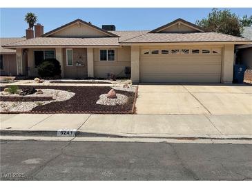 Charming single-story home with a well-maintained front yard and two-car garage at 6241 Pinewood Ave, Las Vegas, NV 89103