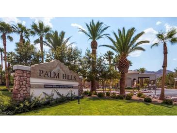 Inviting Palm Hills community entrance with lush landscaping and swaying palm trees offering a warm welcome at 66 John Stuart Mill St, Henderson, NV 89002