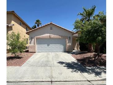 Charming single-story home features a two-car garage, desert landscaping, and a concrete driveway at 8756 Shady Pines Dr, Las Vegas, NV 89143
