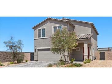 Charming two-story home features a well-manicured lawn and a neutral color scheme at 9054 Tangerine Tree Ct, Las Vegas, NV 89113