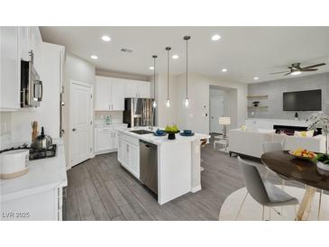 Open-concept kitchen features stainless steel appliances, a large island, and modern finishes at 10270 Turkish Pine Ct, Las Vegas, NV 89166