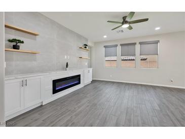 Bright living room featuring a modern fireplace, floating shelves, and neutral tones at 10270 Turkish Pine Ct, Las Vegas, NV 89166