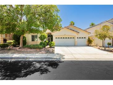 Charming single-story home with a well-manicured lawn and a two-car garage at 1311 Rolling Sunset St, Henderson, NV 89052