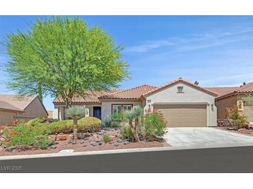 Charming single-story home featuring a well-manicured lawn, desert landscaping, and a two-car garage at 2292 Saxtons River Rd, Henderson, NV 89044