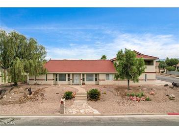 Charming single story home featuring desert landscaping, covered entry, and large windows at 301 E Longacres Dr, Henderson, NV 89015