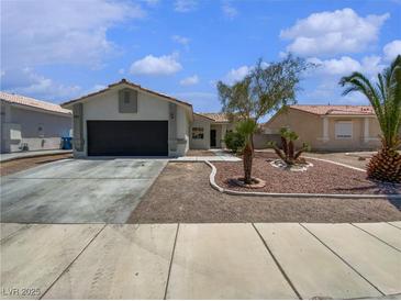 Charming single-story home featuring desert landscaping, a two-car garage, and a welcoming facade at 3109 W Colton Ave, North Las Vegas, NV 89032