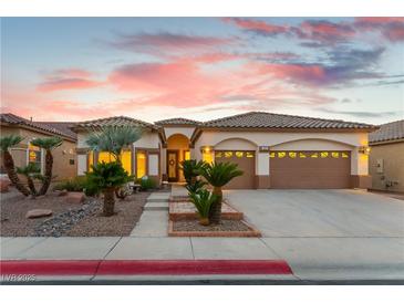 Charming single-story home featuring a well-manicured front yard with desert landscaping and a two-car garage at 379 Marlin Cove Rd, Henderson, NV 89012