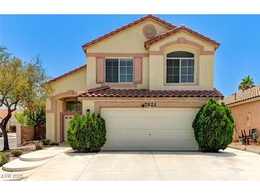 Charming two-story home with a red tile roof, a two-car garage, and well-maintained landscaping at 7521 Reindeer Ct, Las Vegas, NV 89147