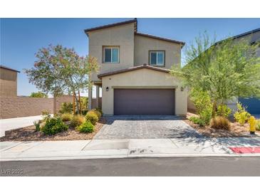 Charming two-story home featuring a well-maintained front yard and a two-car garage at 8254 Palladium St, Las Vegas, NV 89113