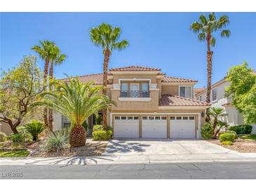 Elegant two-story home with a tile roof, three-car garage, balcony, and mature palm tree landscaping at 8825 Rozetta Ct, Las Vegas, NV 89134