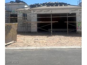 Unfinished home with two-car garage being built and scaffolding at 10266 Rosemont Hills St, Las Vegas, NV 89141