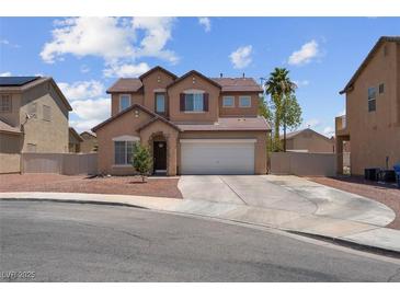 Charming two-story home features a desert landscape, attached garage, and neutral color palette at 5228 Giallo Vista Ct, North Las Vegas, NV 89031
