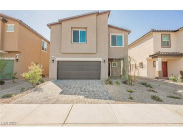Inviting two-story home with a modern design and a neatly paved driveway at 6148 Vista Teal Ln, Las Vegas, NV 89115