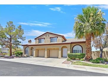 Charming home featuring an attached garage, well-maintained landscaping and mature trees at 690 Ambling Gait Ave, Henderson, NV 89015