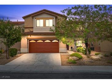 Inviting two-story home featuring a well-maintained yard and a two-car garage, perfect for a Gathering at 7028 Weavers Pl, North Las Vegas, NV 89084