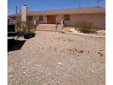 Ranch-style home with a front entrance accessed by exterior stairs at 7052 W Meranto Ave, Las Vegas, NV 89178