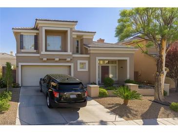 Charming two-story home with a well-manicured front yard, desert landscaping, and an attached two-car garage at 10316 Neopolitan Pl, Las Vegas, NV 89144
