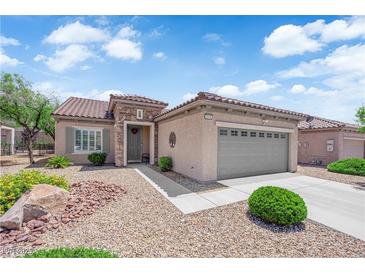 Charming single-story home with stone accents, desert landscaping, and a two-car garage in a sunny setting at 2279 Keego Harbor St, Henderson, NV 89052