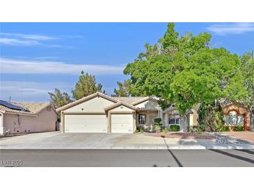 Charming single-story home with a two-car garage and a mature tree in the front yard at 4624 Windy Hollow St, Las Vegas, NV 89130
