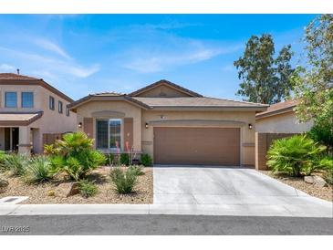 Charming single-story home with desert landscaping, a two-car garage and a tile roof at 4937 Graziano Ave, Las Vegas, NV 89141