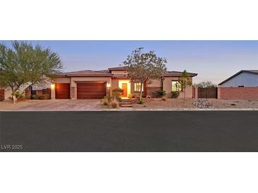 Beautiful single-story home with a well-manicured yard and a spacious three-car garage at 5801 Exbury Gardens Ct, Las Vegas, NV 89118
