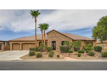 Charming single-story home featuring a stone facade, three-car garage, and well-manicured landscaping at 8032 Audubon Canyon St, Las Vegas, NV 89131
