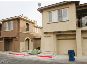 Two-story townhomes with neutral stucco exteriors and attached garages at 10231 Delray Beach Ave # 201, Las Vegas, NV 89129