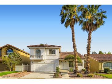 Charming two-story home with a well-maintained yard and Spanish tile roof, complemented by mature palm trees at 1547 Balsam Mist Ave, Las Vegas, NV 89183