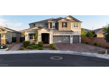 Two-story home showcasing a three-car garage and a well-maintained front yard with manicured landscaping at 2913 Monate Ct, Henderson, NV 89044